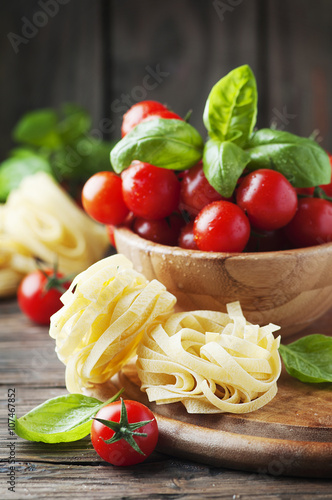 Concept of italian food with pasta, basil and tomato