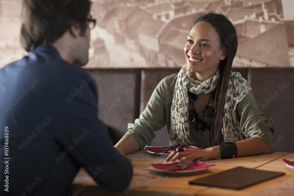 Smiling couple talking in cafe Smiling couple talking in cafe