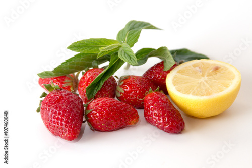 Fototapeta Naklejka Na Ścianę i Meble -  Organic strawberries with lemon and mint on a white background
