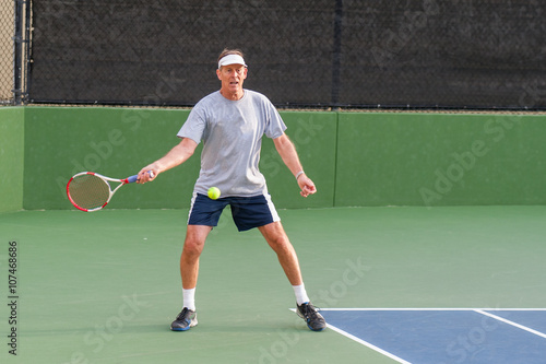 Senior age man showing perfect set up on forehand.  © motionshooter