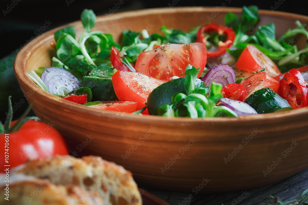 Fresh vegetable salad with tomatoes, cucumbers and onions. Serve Fresh vegetable salad with tomatoes, cucumbers and onions. Serve