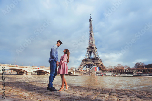 honeymoon in Paris, young beautiful couple on Eiffel Tower background © Song_about_summer