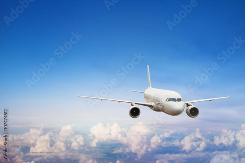 travel by plane  international flight  airplane flying in blue sky above the clouds