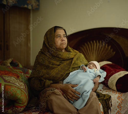 Grandmother holding baby grandson photo