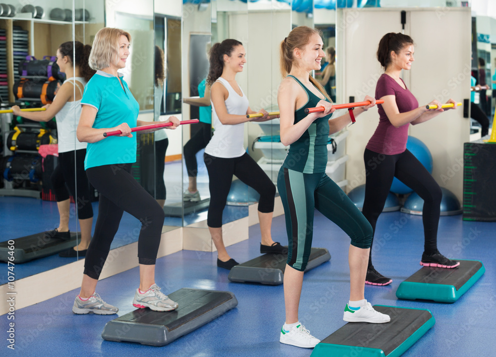 Fototapeta premium Females working out on aerobic step platform