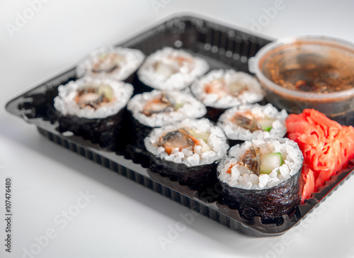 Open Sushi delivery box on white background. Angle view.
