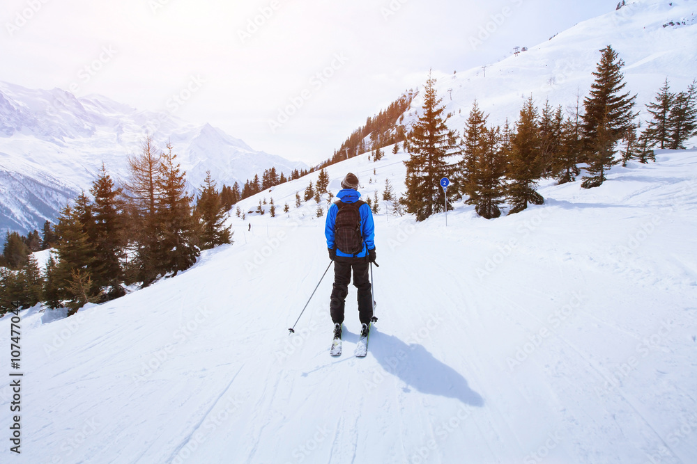 skiing in Alps, winter sport in mountains, skier and beautiful landscape