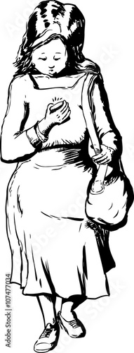 Woman walking at using phone while looking down