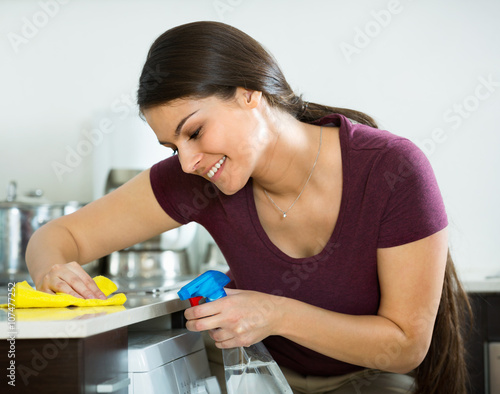  housewife with rag and cleanser cleaning up