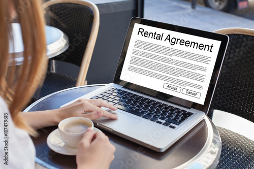 rental agreement, rent a car or house, woman reading tenancy contract on the screen of laptop