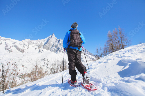 snowshoeing in mountains, hiker in winter alps