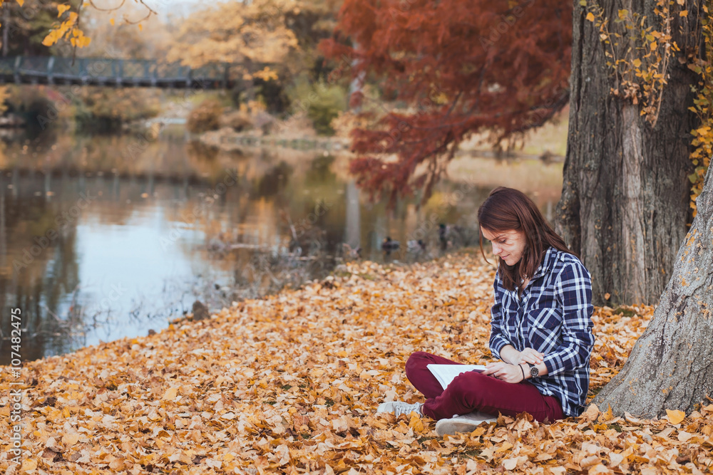reading concept, young woman with book in autumn park reading concept, young woman with book in autumn park