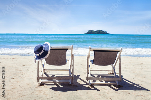 Fototapeta summer holidays on paradise beach, two deckchairs near the sea, family vacations