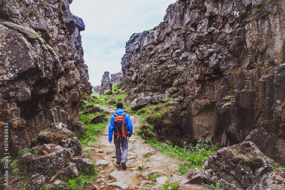 hiking in rocky canyon, backpacker walking in the nature, Iceland