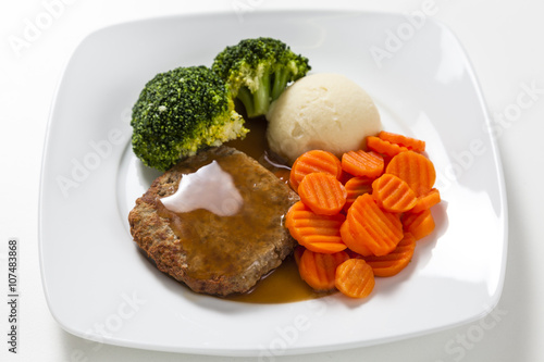 Obraz na plátně Beef rissoles with gravy and vegetables