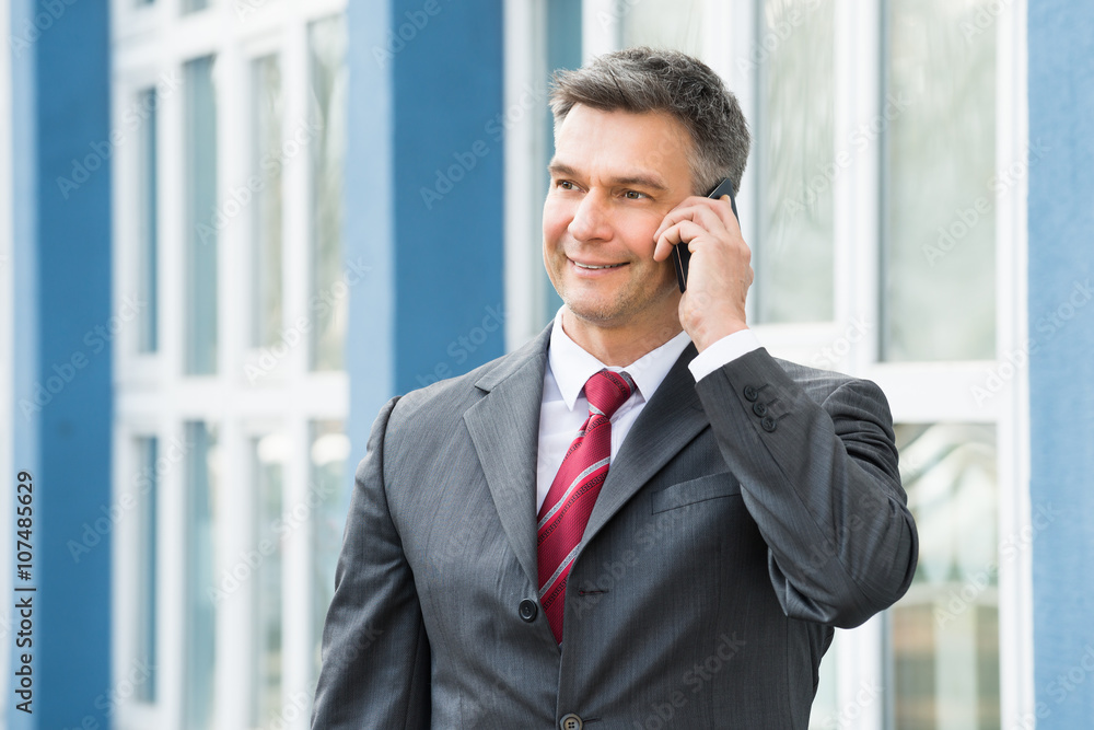 Mature Businessman Talking On Cellphone Mature Businessman Talking On Cellphone