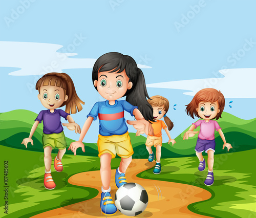 Girls playing soccker in the park