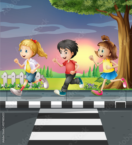 Three kids running along the road
