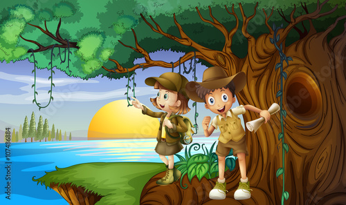 Two kids camping by the river