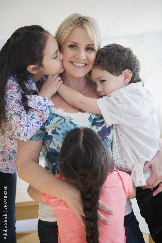 Close up of Caucasian mother and children hugging Close up of Caucasian mother and children hugging