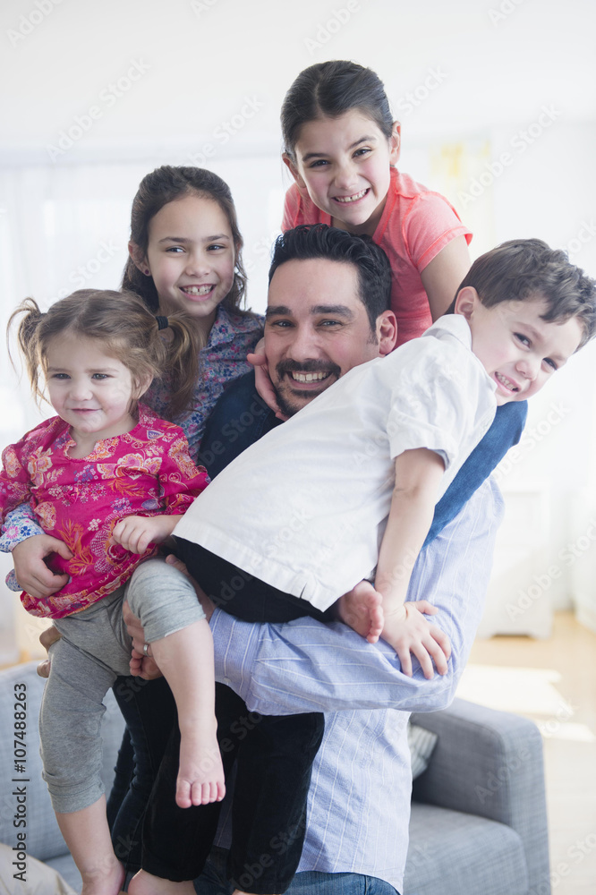 Caucasian father and children relaxing in living room Caucasian father and children relaxing in living room