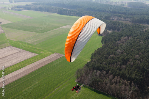 aerial view of paramotor flying over the fields i photo