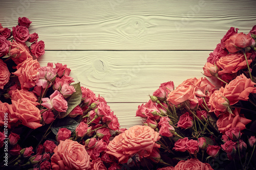 Roses on wooden background