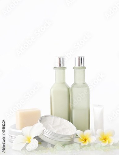 Set of different cosmetic product with frangipani flowers