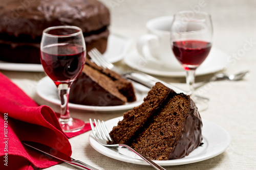 Chocolate cake and glasses of wine.