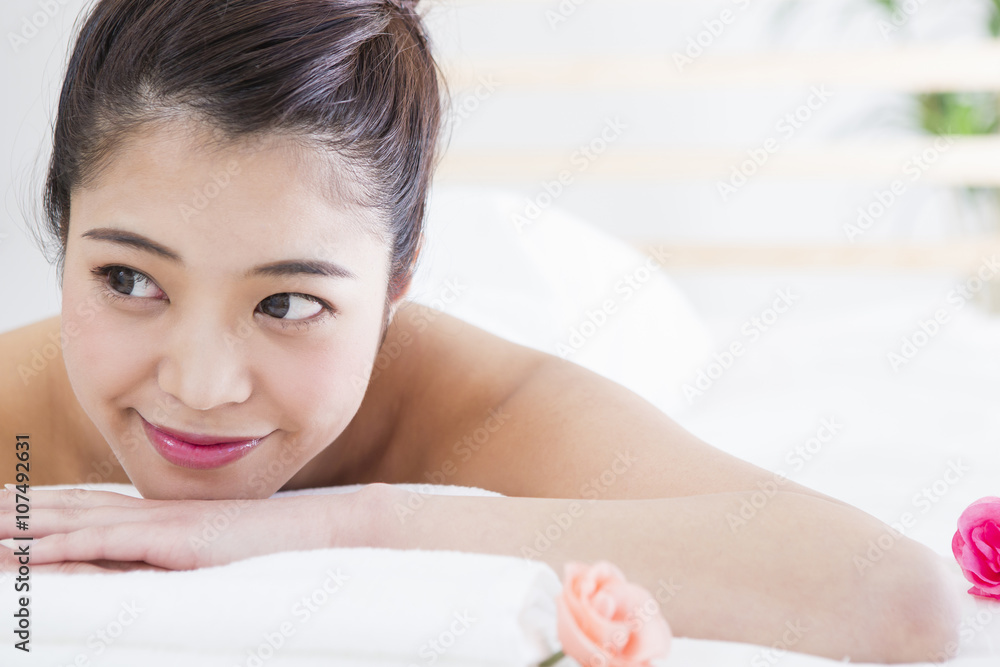 エステベッドに寝転ぶ女性