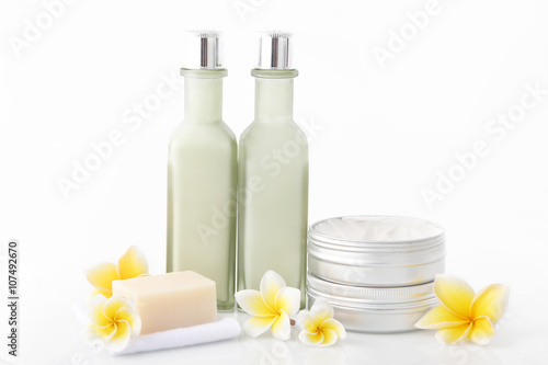 Set of different cosmetic product with frangipani flowers