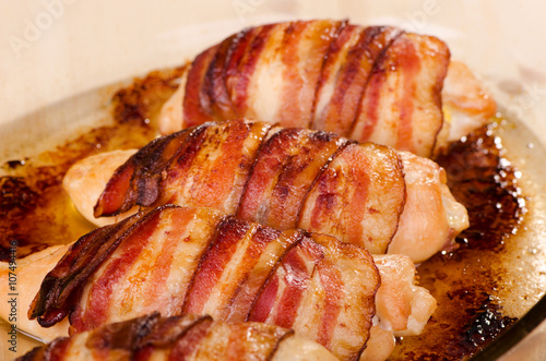 Baked chicken fillet wrapped in bacon