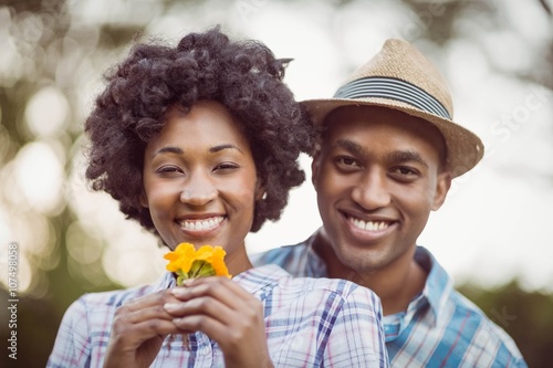 Smiling couple holding yellow flowers