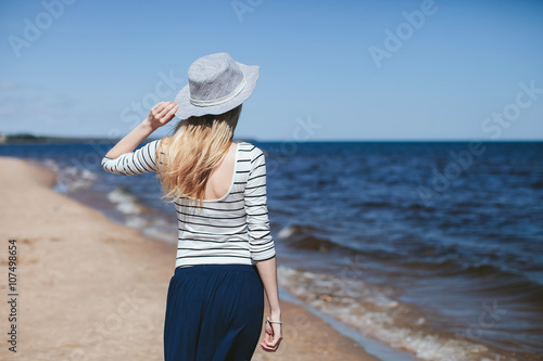 girl in the hat is back on the beach