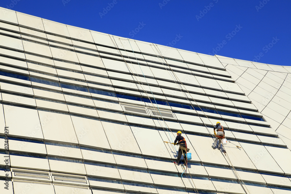 Workers wash the modern office building