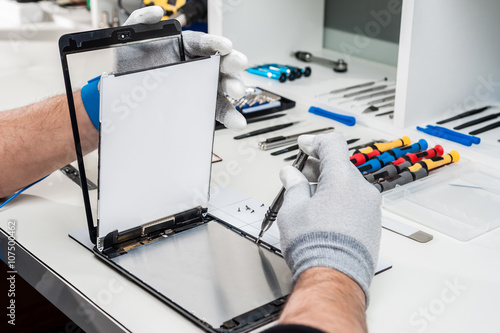 Close-up photos showing process of tablet device repair