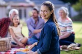 Happy woman having a picnic with her family
