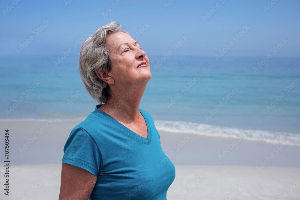 Senior woman with eyes closed on the beach Senior woman with eyes closed on the beach