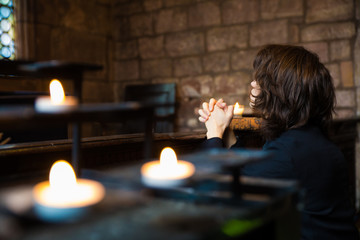Young Man Praying and Meditating in a Church