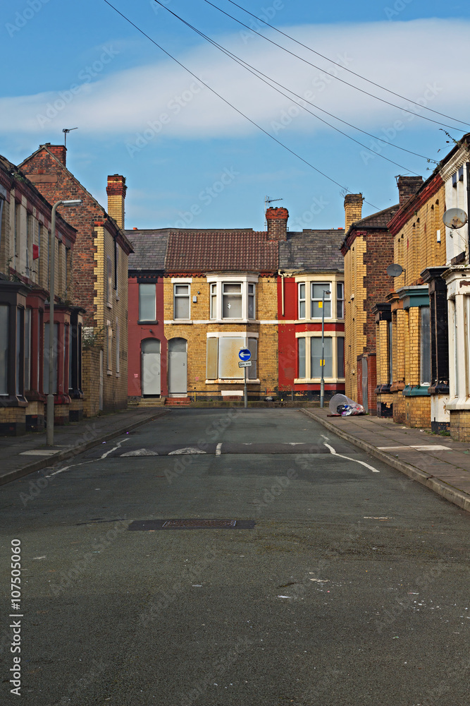 Obraz premium A street of boarded up derelict houses awaiting regeneration in Liverpool UK
