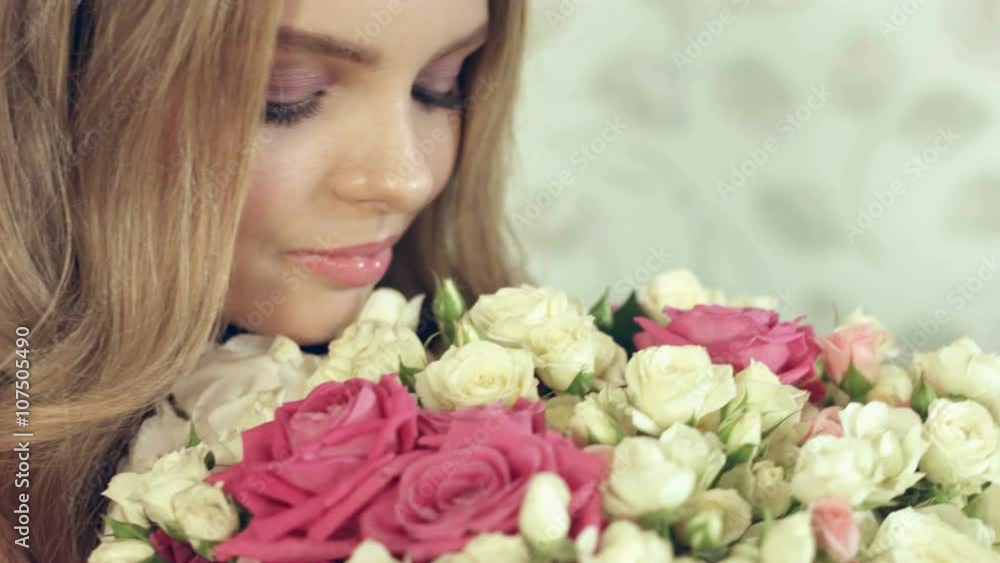 Happy girl with a large bouquet of small roses Happy girl with a large bouquet of small roses