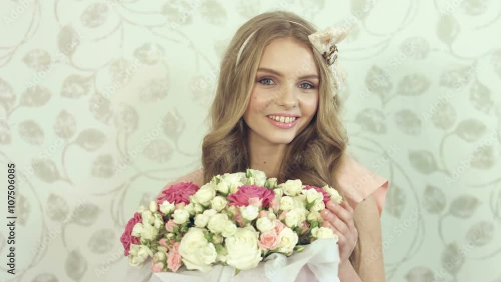 Gentle young woman with beautiful big bouquet at photosession Gentle young woman with beautiful big bouquet at photosession