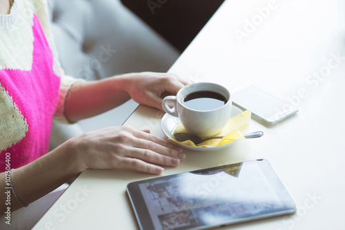 Female hand on the table, technology, internet, woman drinking coffee