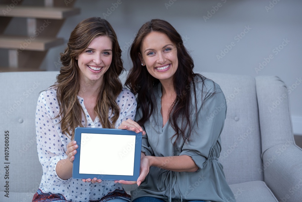 Two beautiful woman holding digital tablet Two beautiful woman holding digital tablet