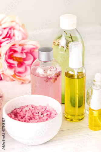 Spa setting with pink roses and aroma oil, vintage style 