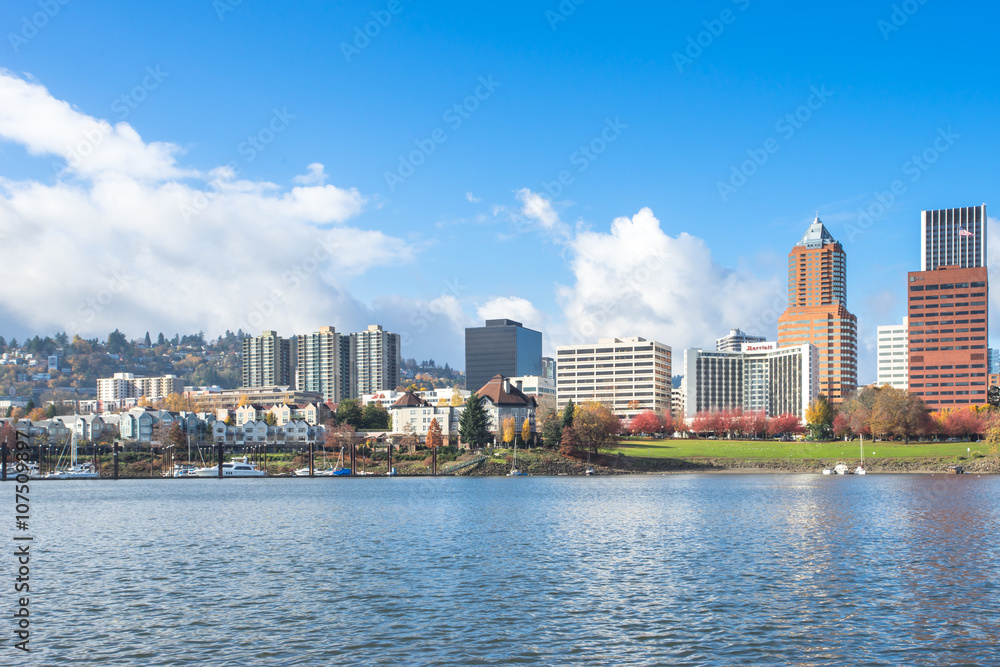 Fototapeta premium tranquil water with cityscape and skyline of portland