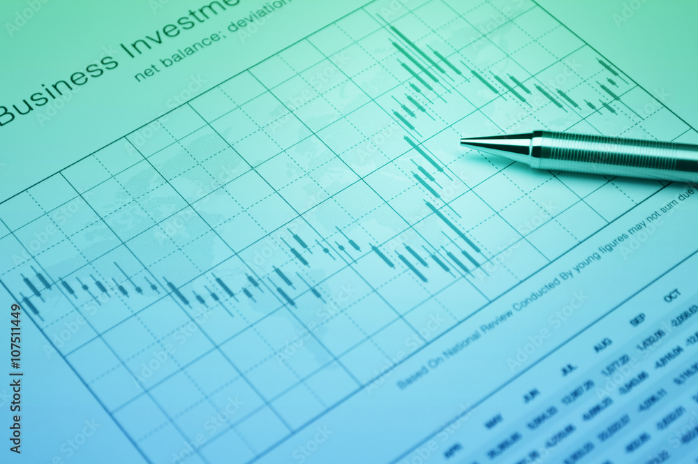Pencil on stock market graph, financial concept Pencil on stock market graph, financial concept