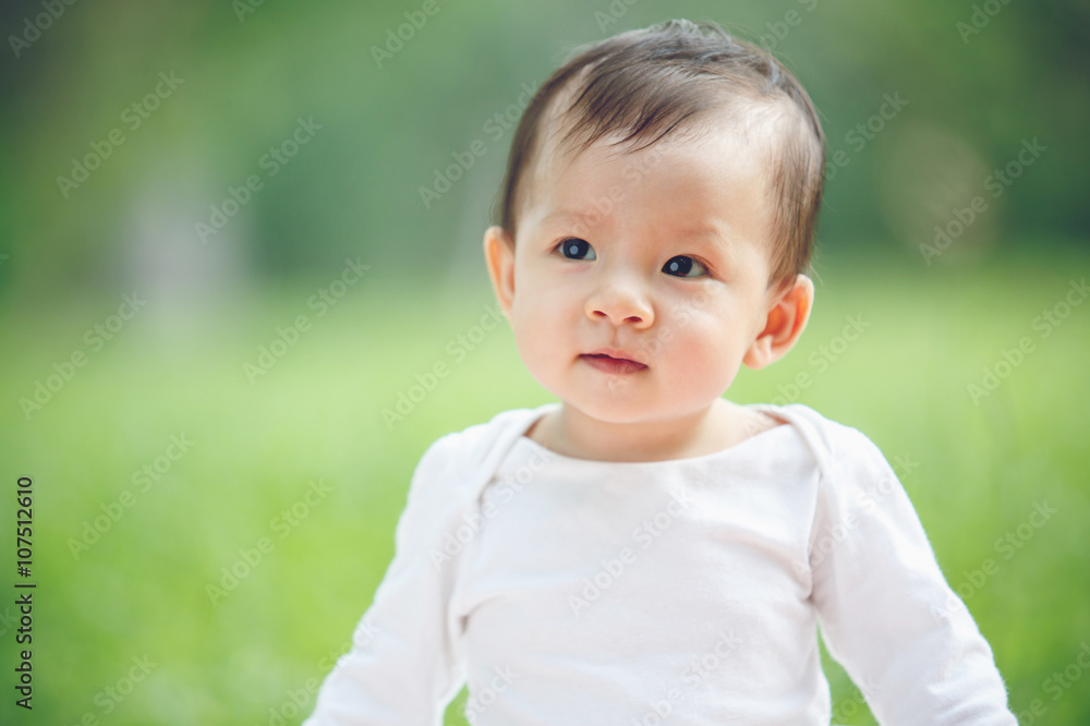 Baby looking away in garden (soft focus on the eyes) Baby looking away in garden (soft focus on the eyes)