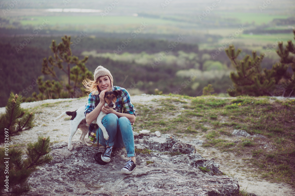 Woman and her dog posing outdoor. 