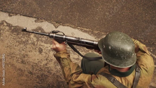 German soldier of war world two shoots from mashinegun in slow motion photo